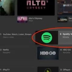 Ikona Spotify na liście aplikacji telewizyjnych, obok YouTube i Netflix.